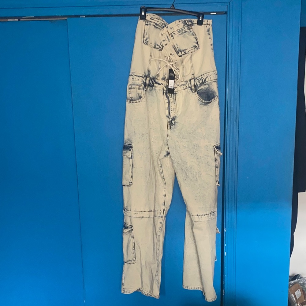 Denim jumpsuit. Ties in front of chest area. Cargo Denim jumpsuit.